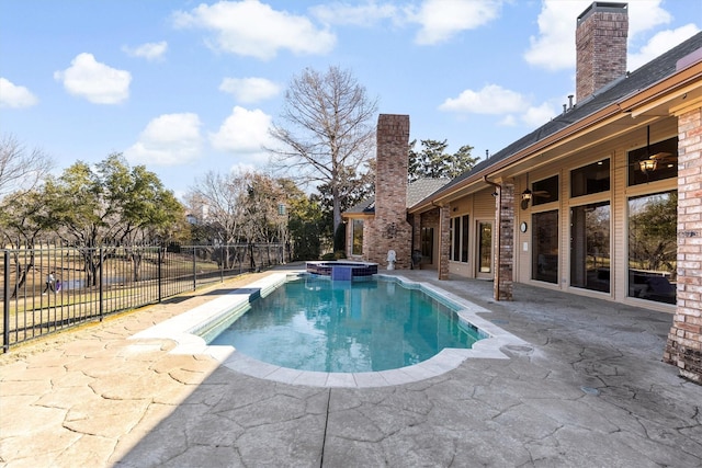 view of pool with a patio and an in ground hot tub