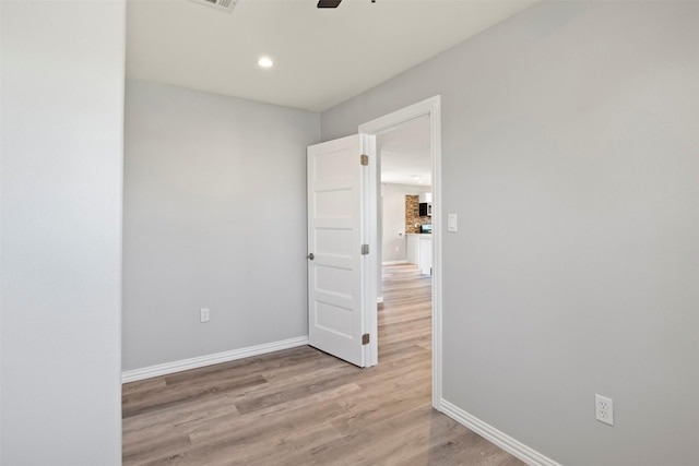 empty room featuring ceiling fan and light wood-type flooring