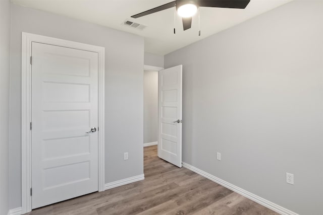 unfurnished bedroom featuring ceiling fan and light hardwood / wood-style floors