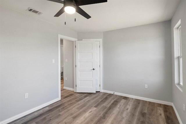 spare room featuring hardwood / wood-style floors and ceiling fan