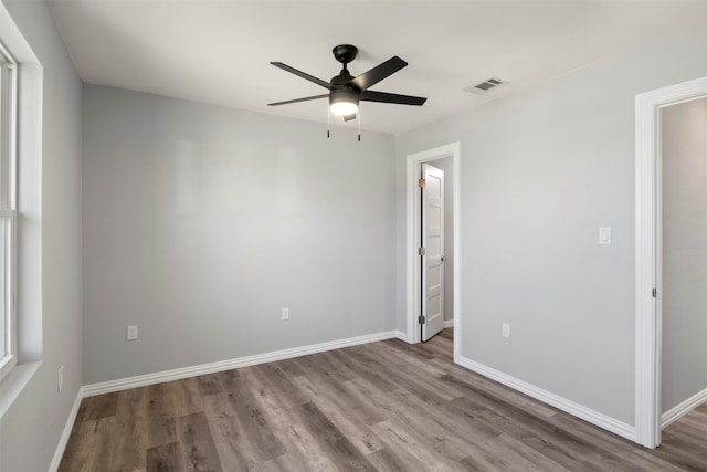 unfurnished room with ceiling fan and light wood-type flooring