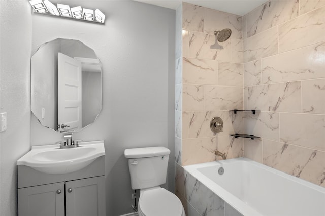 full bathroom featuring vanity, tiled shower / bath combo, and toilet