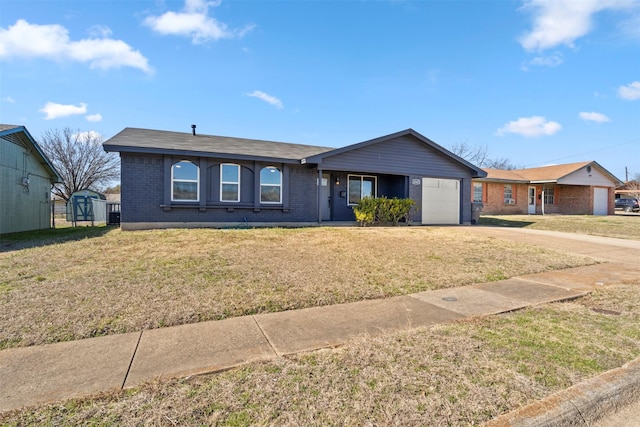 ranch-style home featuring a garage and a front yard