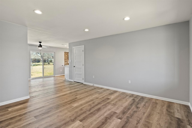 empty room featuring hardwood / wood-style floors and ceiling fan