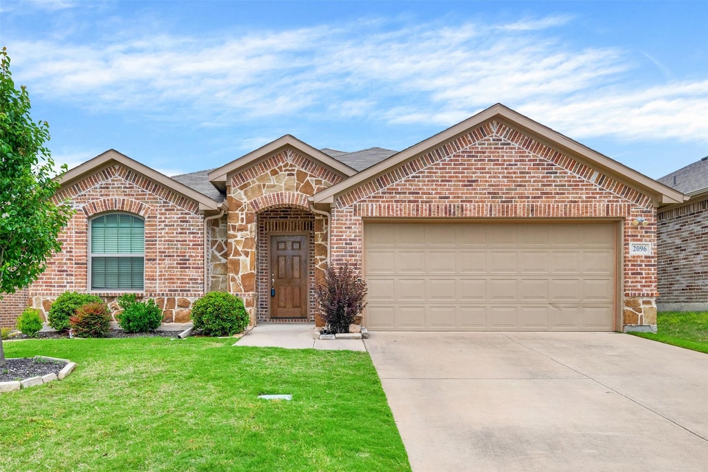 view of front of house with a garage and a front lawn