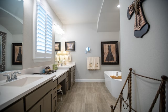 bathroom with vanity and a washtub