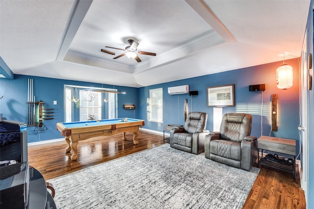 playroom with billiards, a wall mounted air conditioner, ornamental molding, dark hardwood / wood-style floors, and a raised ceiling