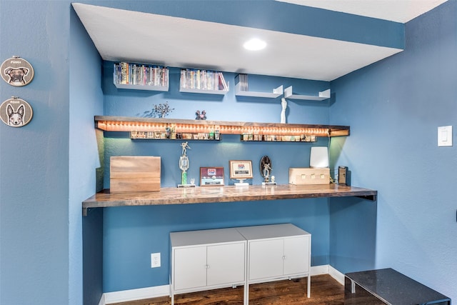 bar with dark hardwood / wood-style floors