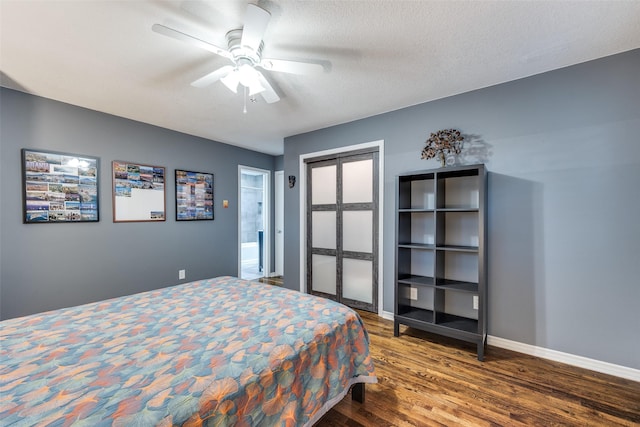 bedroom featuring hardwood / wood-style flooring, ceiling fan, and a textured ceiling