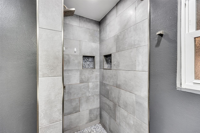 bathroom with a tile shower