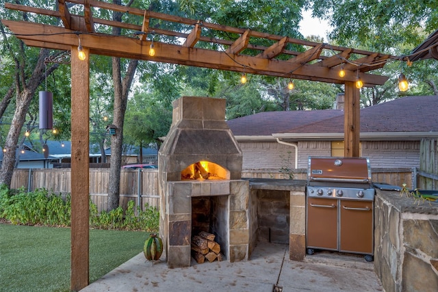 view of patio featuring exterior kitchen, a grill, exterior fireplace, and a pergola