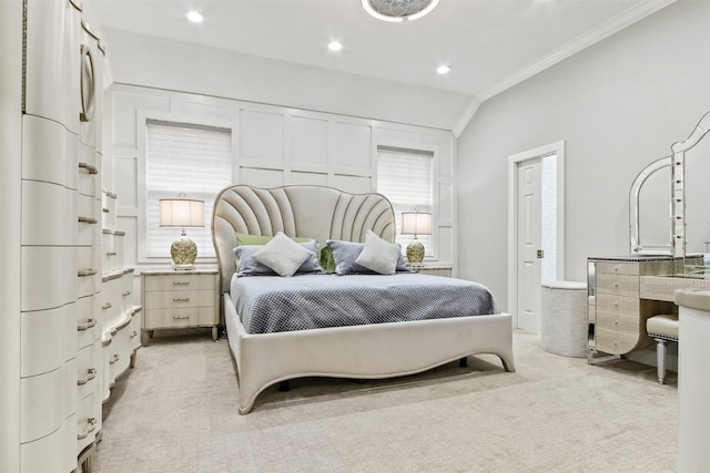 bedroom with light colored carpet, lofted ceiling, and ornamental molding