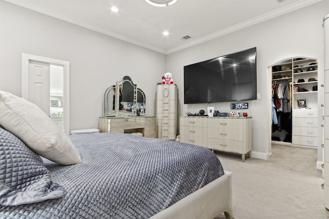 bedroom featuring light colored carpet, ornamental molding, and a spacious closet