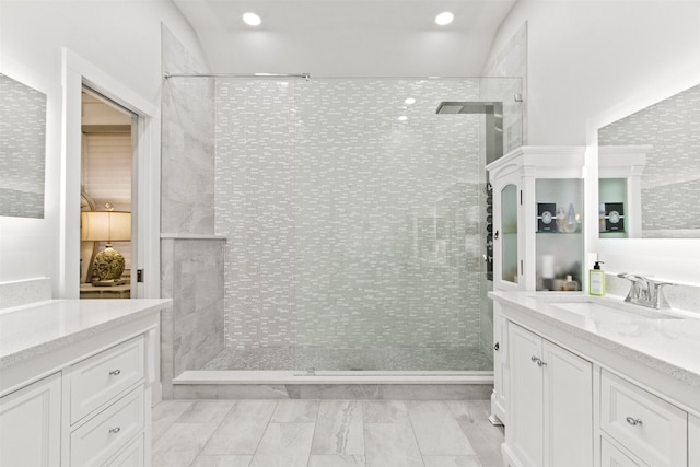 bathroom featuring vanity and a tile shower