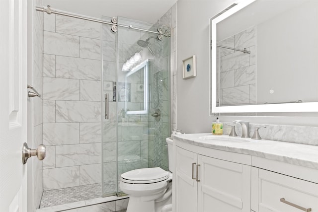 bathroom with walk in shower, vanity, and toilet