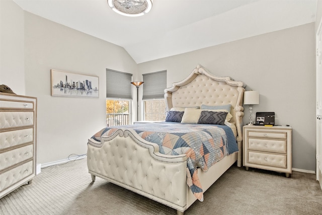 carpeted bedroom featuring vaulted ceiling