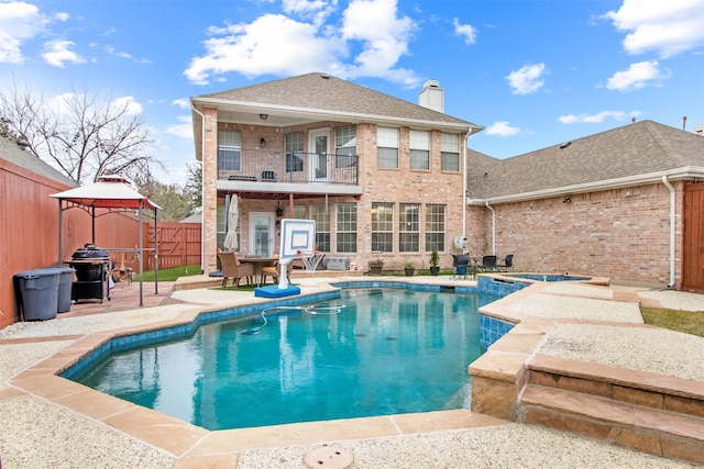 view of pool with a patio, a gazebo, and an in ground hot tub