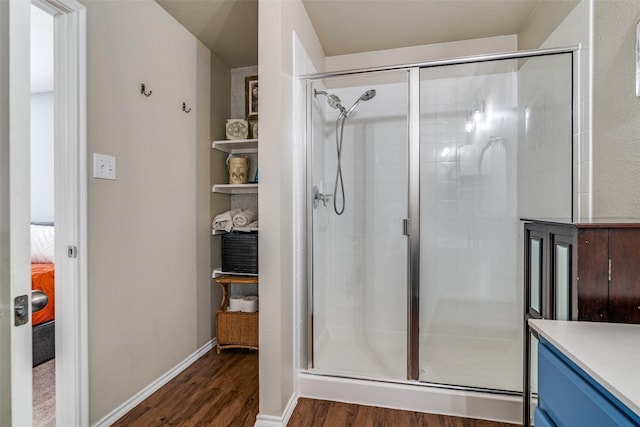 bathroom featuring hardwood / wood-style flooring and a shower with shower door