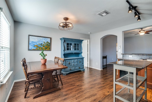 dining room featuring a healthy amount of sunlight, dark hardwood / wood-style floors, sink, and ceiling fan