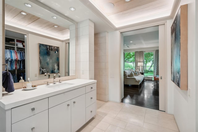 bathroom with tile patterned floors, vanity, and tile walls