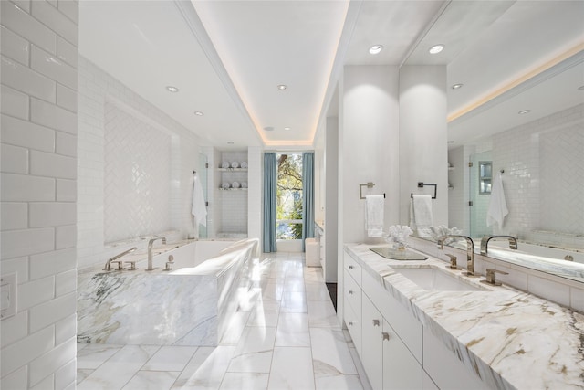 bathroom featuring walk in shower, a garden tub, vanity, and recessed lighting