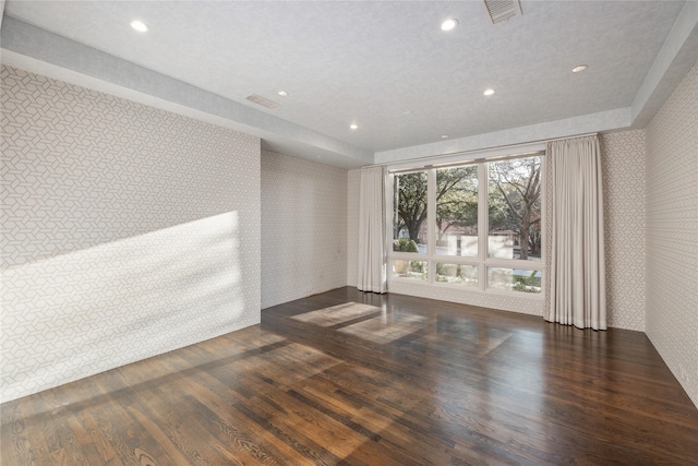 spare room featuring wallpapered walls, visible vents, wood finished floors, and recessed lighting