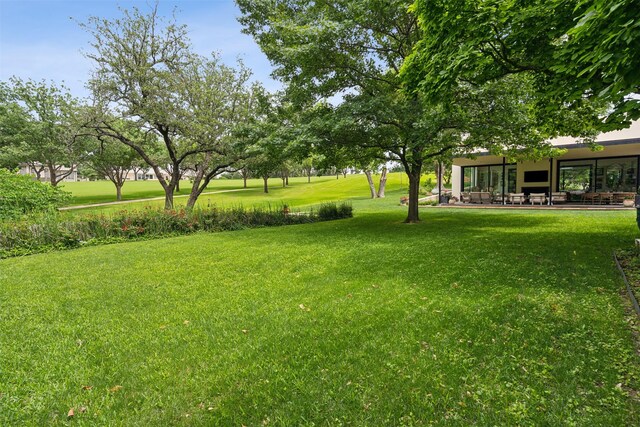 rear view of property featuring french doors and a lawn