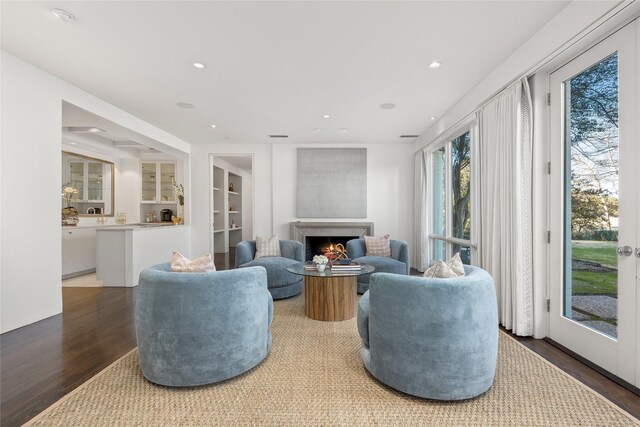 living room featuring dark wood-type flooring and plenty of natural light