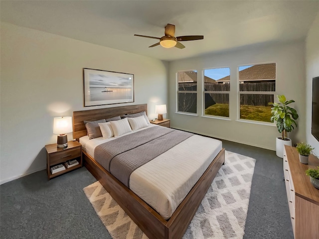 bedroom featuring ceiling fan and dark carpet