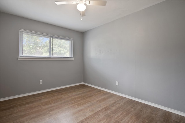 empty room with ceiling fan and wood-type flooring