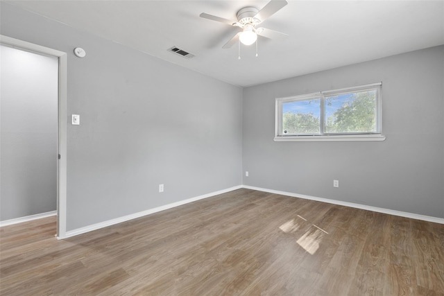 unfurnished room with ceiling fan and light wood-type flooring