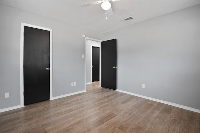 unfurnished bedroom with ceiling fan and light hardwood / wood-style flooring