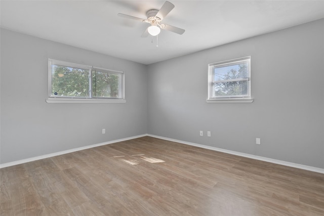 unfurnished room with ceiling fan and light wood-type flooring