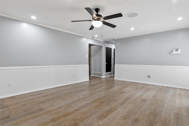 spare room featuring ornamental molding, hardwood / wood-style floors, and ceiling fan