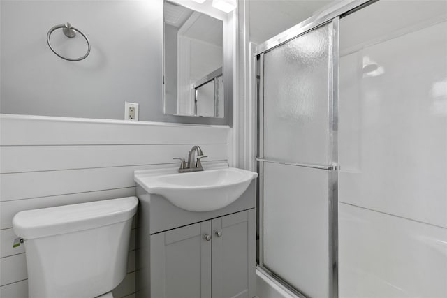 bathroom with vanity, toilet, and walk in shower