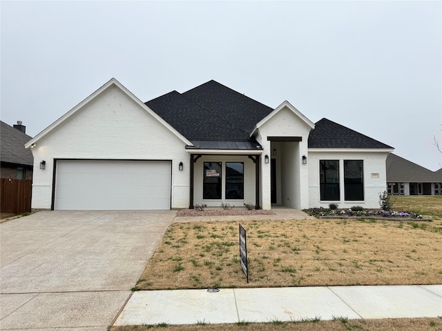 view of front facade with a garage and a front yard