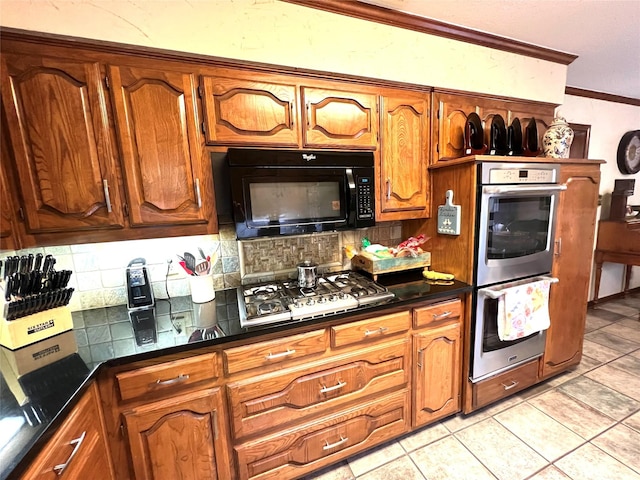 kitchen with tasteful backsplash, crown molding, appliances with stainless steel finishes, and light tile patterned floors