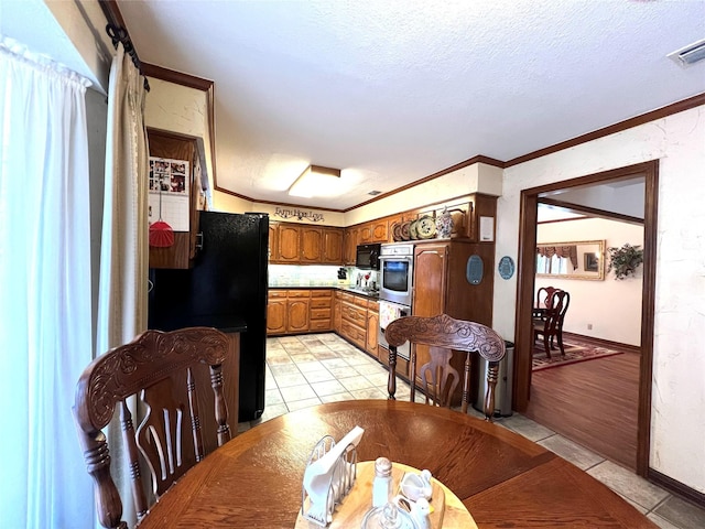 interior space featuring crown molding, a textured ceiling, and light tile patterned floors