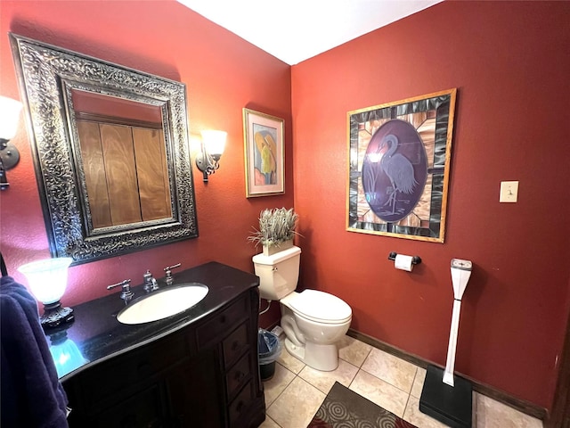 bathroom featuring vanity, tile patterned flooring, and toilet