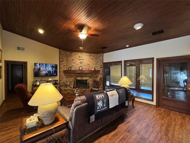 interior space featuring vaulted ceiling, a fireplace, wood-type flooring, ceiling fan, and wood ceiling