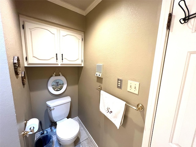 bathroom with ornamental molding and toilet