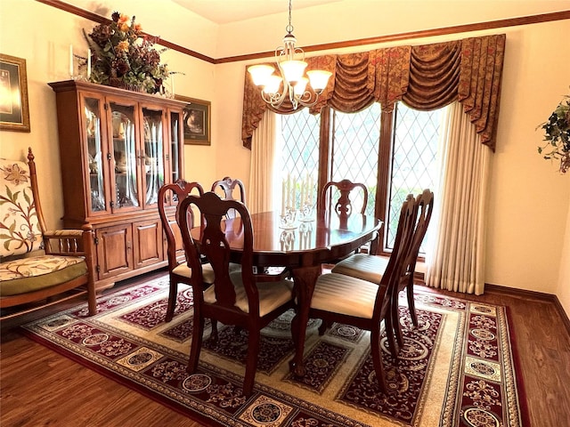 dining area with dark hardwood / wood-style floors and a chandelier