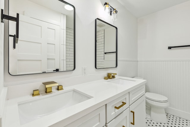 bathroom with vanity, toilet, and tile patterned flooring