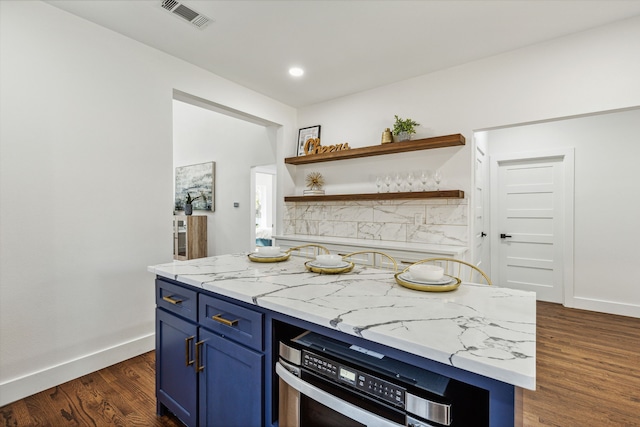 kitchen featuring blue cabinets, light stone countertops, and dark wood-type flooring