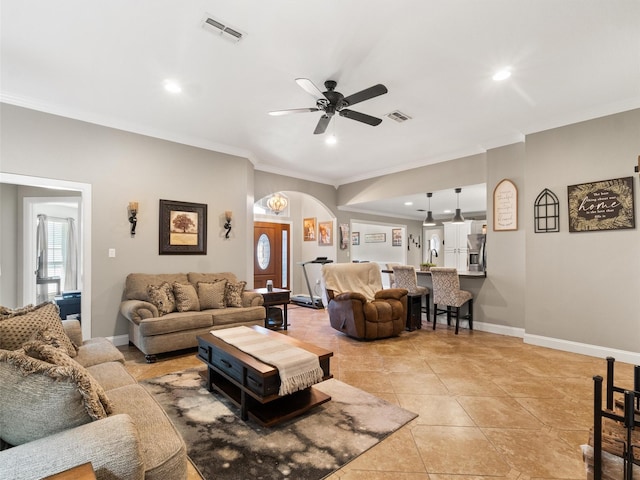 living room featuring crown molding, light tile patterned flooring, and ceiling fan