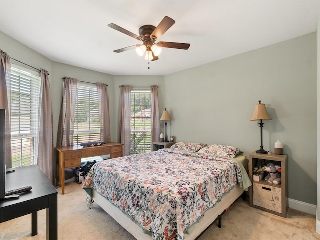 bedroom with light carpet and ceiling fan