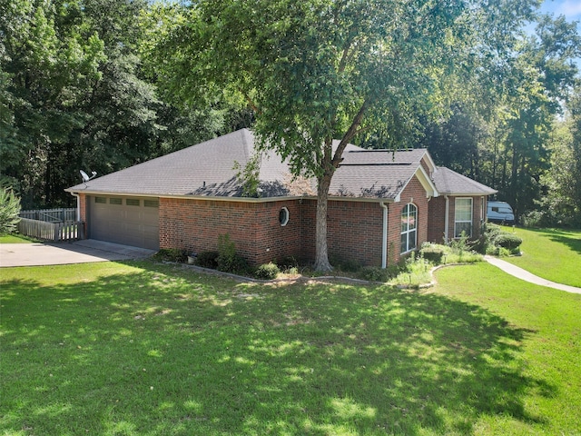 ranch-style house with a garage and a front lawn