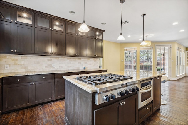 kitchen featuring light stone counters, pendant lighting, and appliances with stainless steel finishes