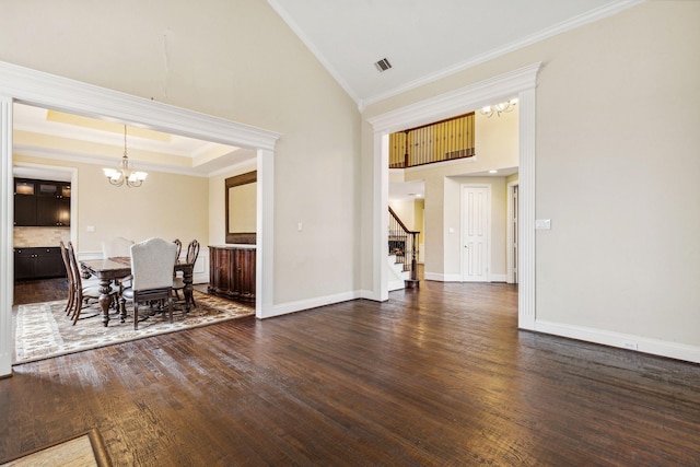 unfurnished dining area featuring an inviting chandelier, dark hardwood / wood-style flooring, high vaulted ceiling, and crown molding