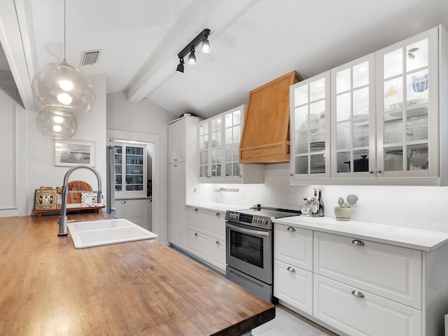 kitchen featuring decorative light fixtures, sink, white cabinets, and stainless steel range with electric stovetop